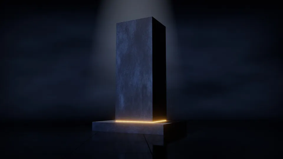 Hoher Monolith aus dunkelblauem Stein auf breitem, niedrigem Sockel; dazwischen läuft eine schmale goldene Lichtfuge um, Licht fällt von oben.